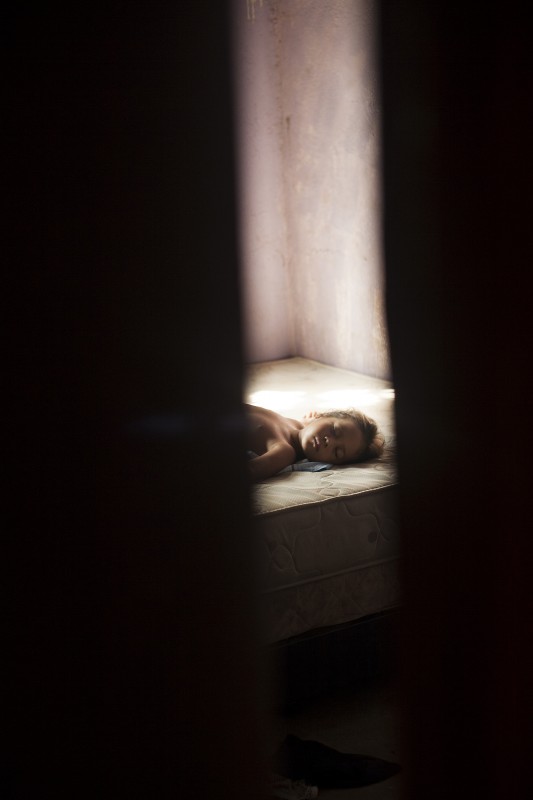 Esecilis, 5, takes a nap at her grandmother Gavelys&#039; house, who often takes care of her grandchildren during the day. It is always hovering around 95-100 degrees in Membrillar. Because of their prior separation, Gavelys&#039; family now clings together.