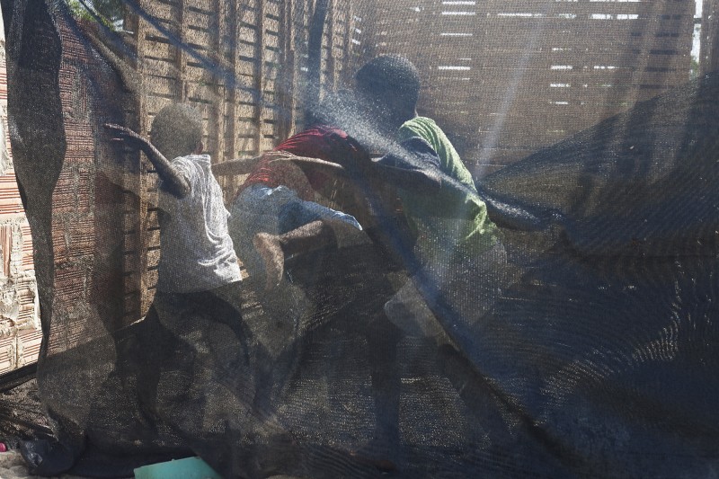 Three boys in Membrillar play near Daylis&#039; house. The people in this area make their homes out of whatever material they can find. Tin roofs and wood and mud walls are common. There is no police station in Membrillar, adding to the community&#039;s vulnerability. In October, Gavelys was robbed at night despite the fact she is close to 50 and a well known member of the community.