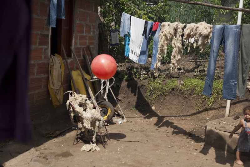 Wool dries on the clothesline in Gavelys&#039; back yard. She weaves the traditional Indigenous bags and sells them in El Centro. A part of her story was told in the women&#039;s play at FUNSAREP; the episode whrein the FARC returned to her farm and slaughtered the livestock as a threat.